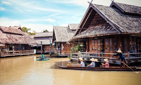 Explore the vibrant and traditional floating market in Thailand, with wooden houses and tourists on boats.